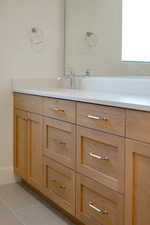 Bathroom featuring light tile patterned flooring and vanity