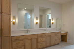 Full bathroom with a shower stall, double vanity, light tile patterned floors, and recessed lighting