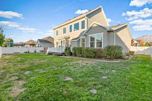 Rear view of property with a fenced backyard, a wooden deck, and stucco siding