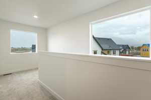 Hall featuring light colored carpet and recessed lighting