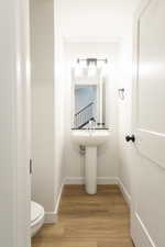 Bathroom featuring baseboards and light wood-style floors