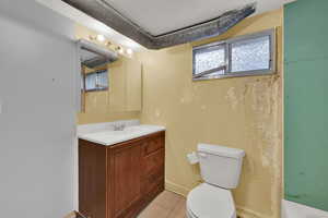 Full bath with vanity and light tile patterned flooring
