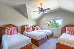 Carpeted bedroom with lofted ceiling, a ceiling fan, and recessed lighting