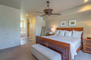 Bedroom featuring recessed lighting, carpet flooring, ensuite bath, a ceiling fan, and electric panel