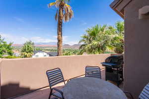 View of patio / terrace with a grill, outdoor dining area, and a mountain view