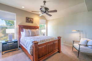 Bedroom with light carpet, a ceiling fan, recessed lighting, and lofted ceiling
