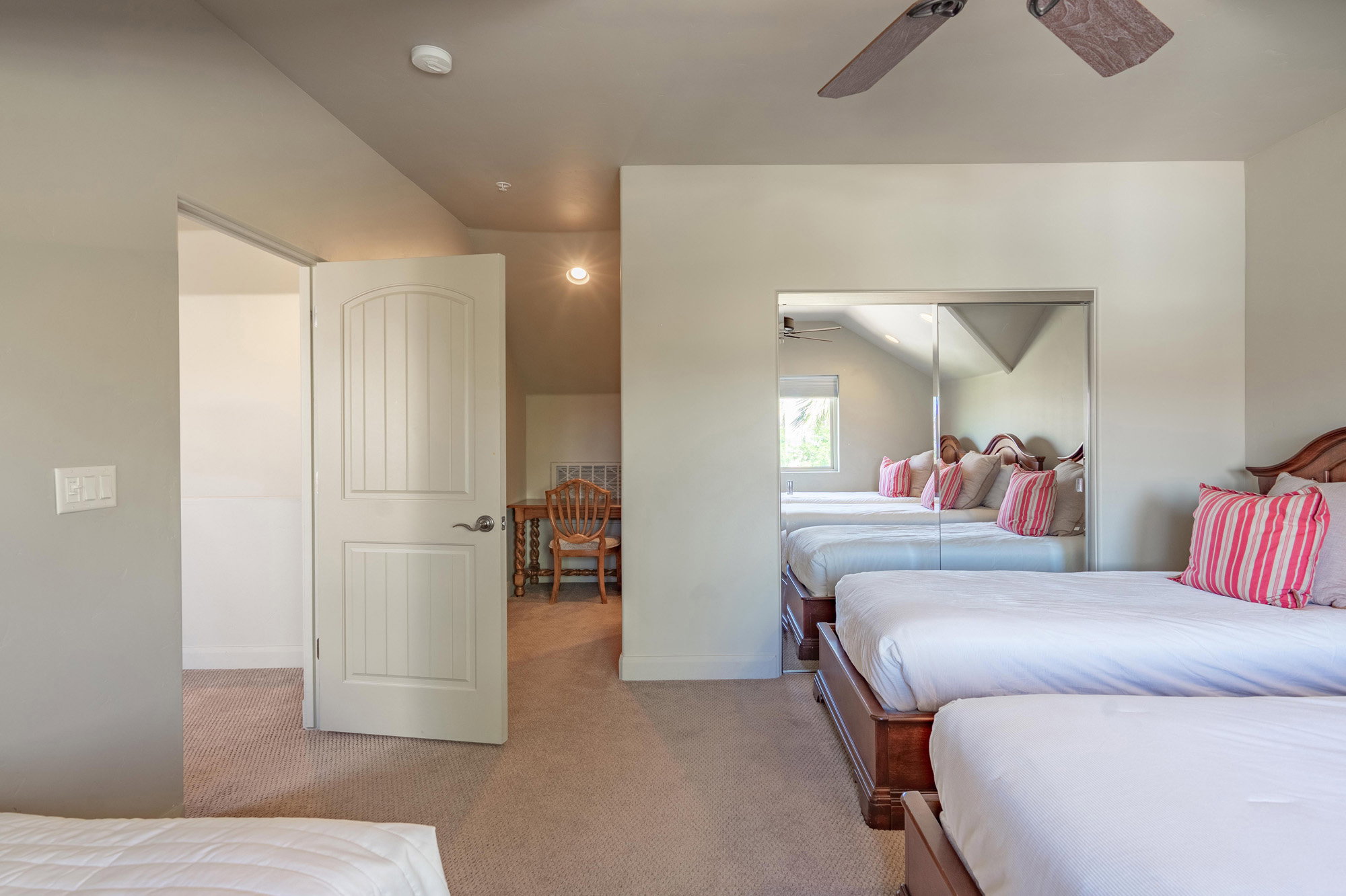 Bedroom featuring light carpet, a closet, and a ceiling fan