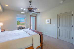 Carpeted bedroom featuring recessed lighting, ceiling fan, and access to outside