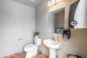 Bathroom with toilet and tile patterned flooring