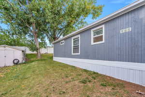 View of yard with a storage unit