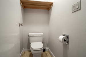 Bathroom featuring light wood-type flooring and baseboards