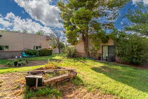View of yard with a vegetable garden and a patio