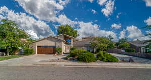 View of front of home featuring brick siding, concrete driveway, and an attached garage