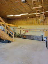 Garage featuring a garage door opener and a heating unit