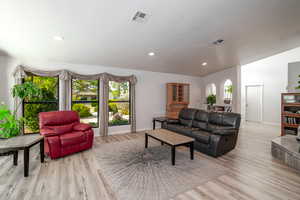 Living area featuring light wood-type flooring and recessed lighting