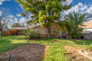 Rear view of property with brick siding, a patio, and stucco siding