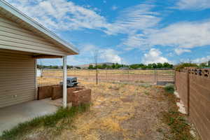 View of yard featuring a patio, a view of rural / pastoral area, a gate, and a mountain view