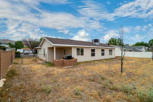 Back of property with a patio and a shingled roof
