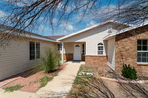 Property entrance featuring brick siding