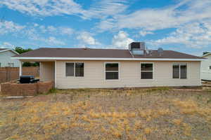 Back of house featuring roof with shingles