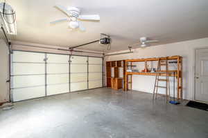 Garage with a ceiling fan and a garage door opener