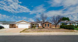 Single story home featuring brick siding, concrete driveway, and a garage