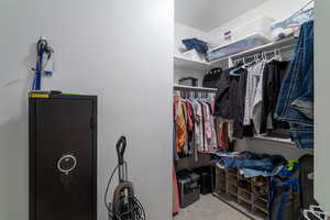 Walk in closet with light colored carpet