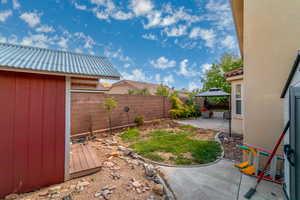 Fenced backyard featuring a gazebo and a patio