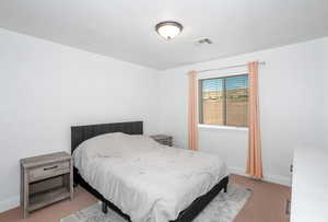 Bedroom featuring carpet and baseboards