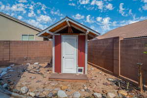 View of shed with a fenced backyard