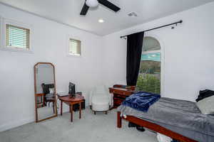 Carpeted downstairs bedroom featuring a ceiling fan and recessed lighting