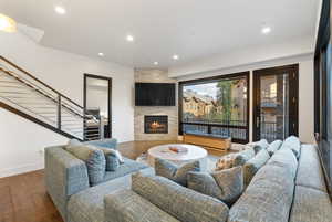 Living room featuring wood finished floors, recessed lighting, a contemporary fireplace.