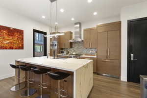 Kitchen with a breakfast bar, Quartz waterfall countertops, and contemporary kitchen cabinets.