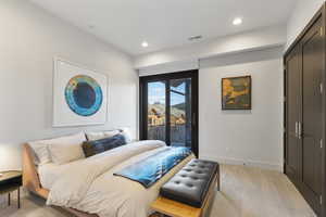 Bedroom with light colored carpet, access to exterior, recessed lighting, and a closet