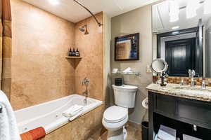 Full bathroom featuring a combined bath / shower with jetted tub, vanity, recessed lighting, and tile patterned floors