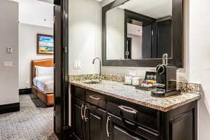 Bathroom featuring vanity and baseboards