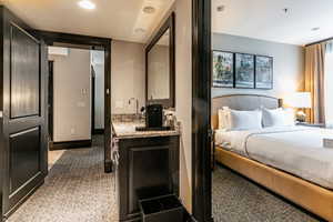 Bedroom with light carpet and recessed lighting