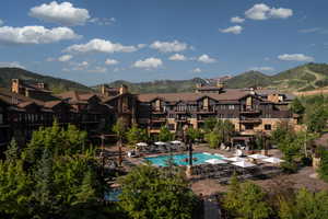 Community pool with a mountain view, a residential view, and a patio