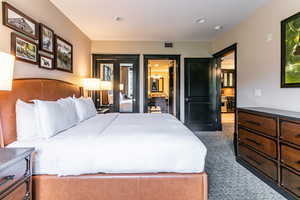 Bedroom with light carpet, recessed lighting, and ensuite bath