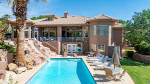 Back of house featuring a patio area, a tiled roof, stucco siding, and french doors