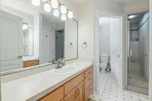 Full bathroom featuring vanity and a shower stall
