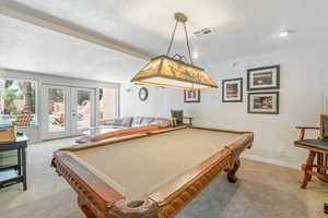 Game room with french doors, light carpet, pool table, a textured ceiling, and recessed lighting