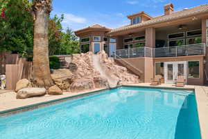 Outdoor pool with a water slide, french doors, ceiling fan, a patio, and stairway