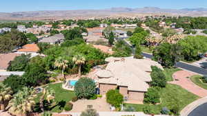 Aerial view of residential area with a mountain backdrop and a pool area