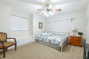 Bedroom featuring light colored carpet and ceiling fan