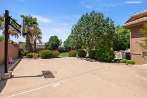 Fenced backyard with basketball hoop