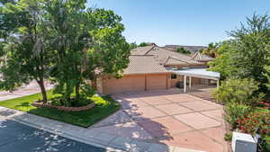 View of front of property with stucco siding, a tiled roof, and a garage