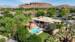 Aerial view of property and surrounding area featuring mountains