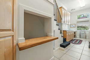Mudroom with light tile patterned flooring and baseboards