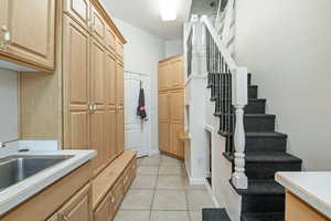Washroom with light tile patterned floors and a sink